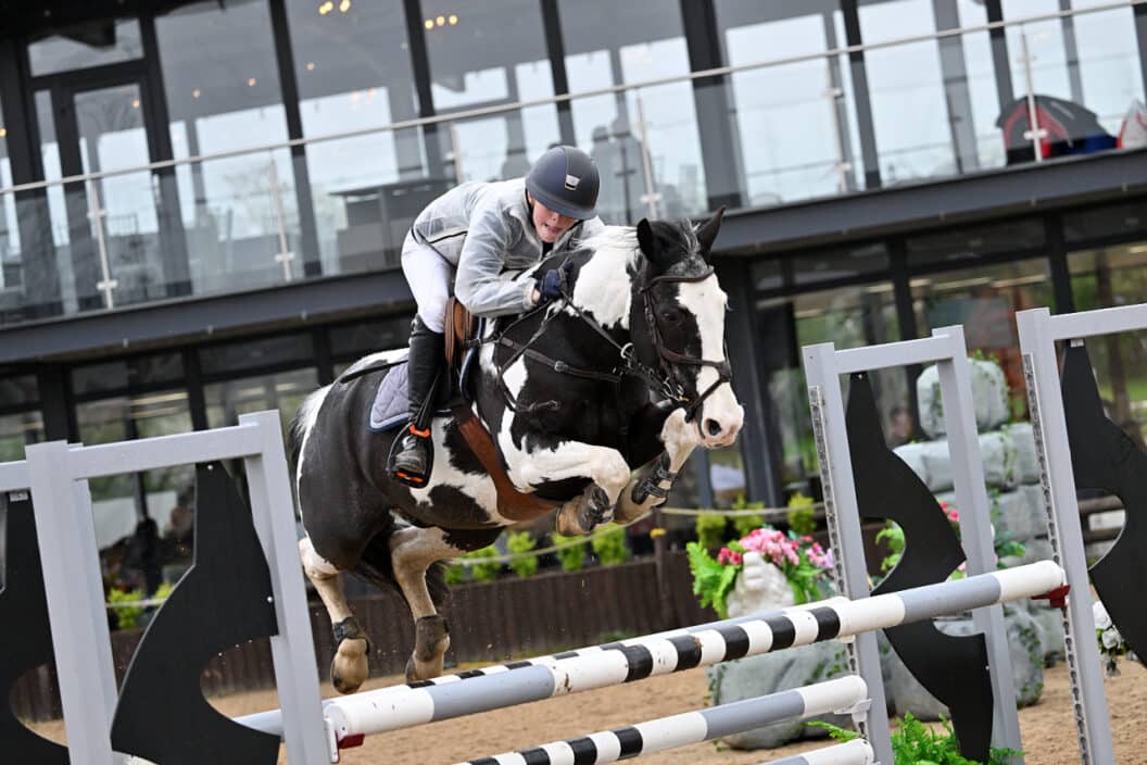 Pony jumping a fence
